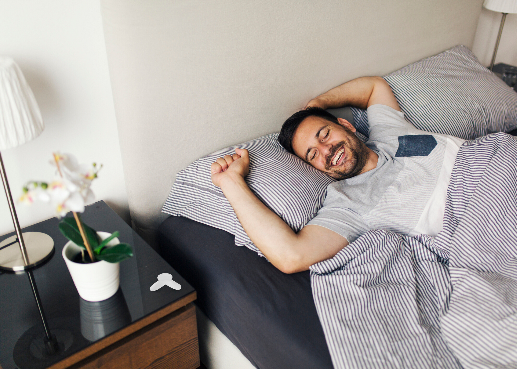 man lying in bed with mouthpiece on night stand