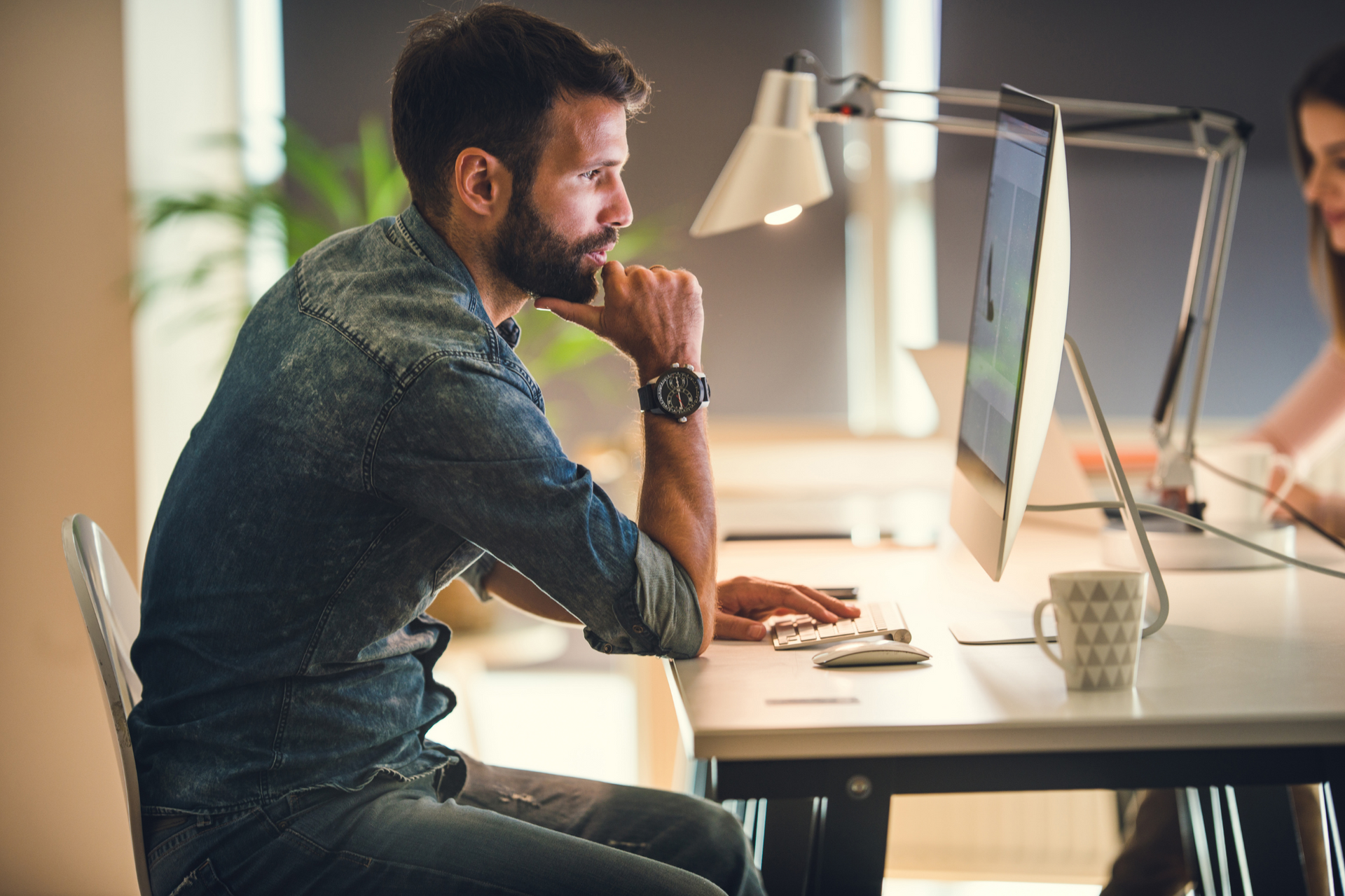 man sitting at computer researching intensely