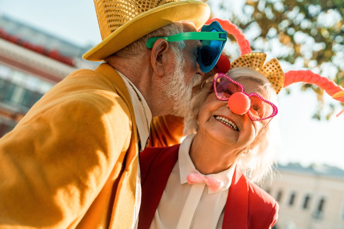 Elderly couple with clowns nose and hats