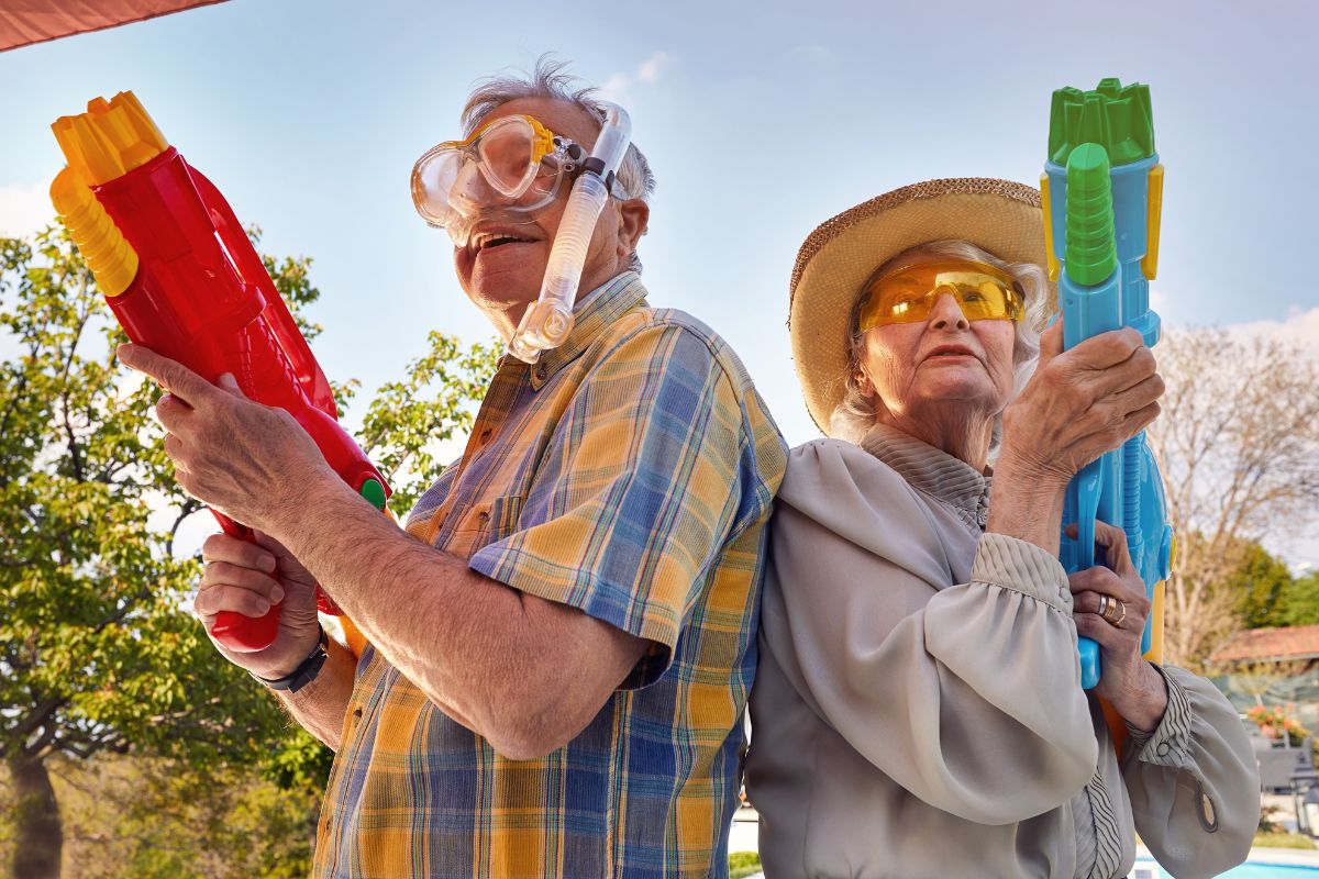 older couple playing water gun game