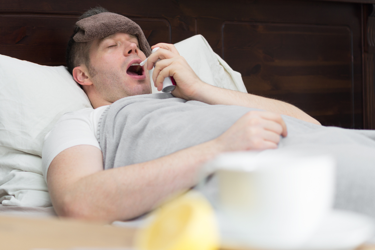 Man spraying antisnore spray in mouth