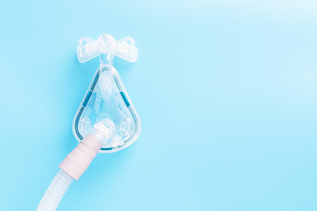 sleep apnea mask on blue background
