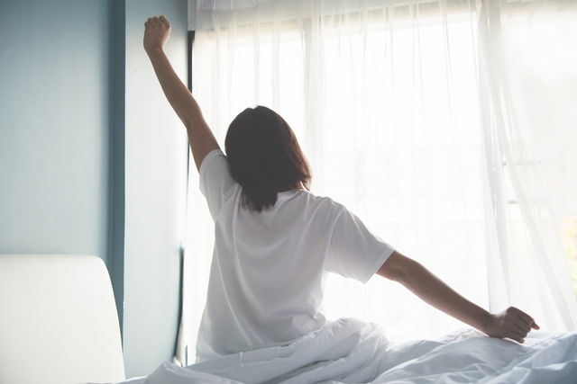 Women stretching and looking at window from behind