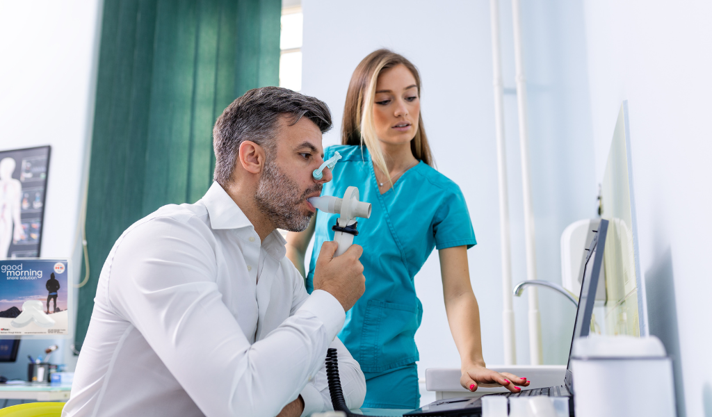 man being assesses by doctor - breathing apparatus