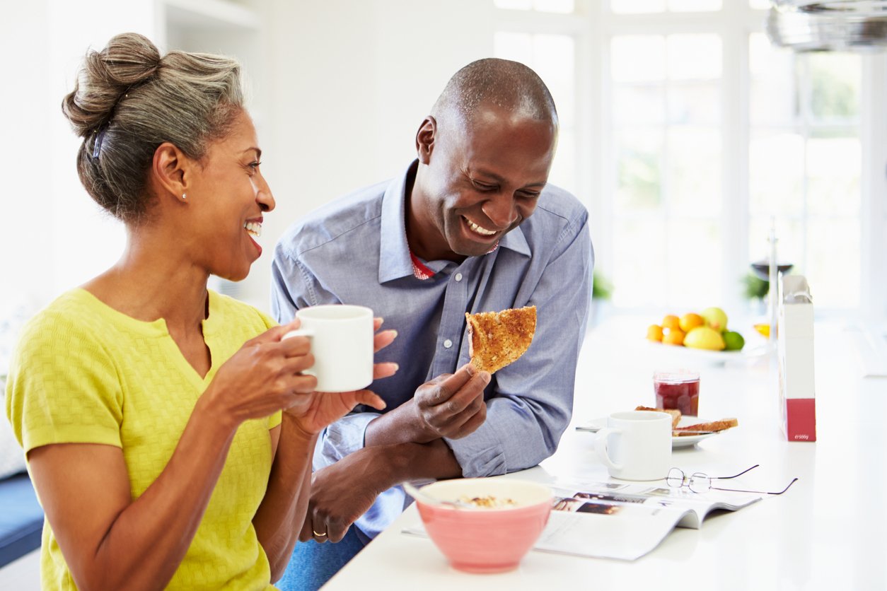 Happy couple eating breakfast